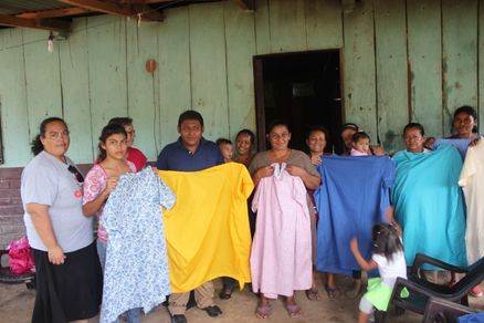 Our sewing group in Nandarola making gowns to donate to the hospital. One man is one of our sewers.