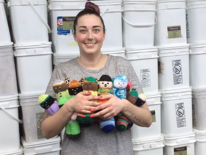 One of our team members Morgan with some of the donated knit dolls. The children absolutely love them