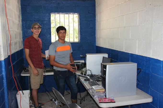 Setting up computers in San Luis. Bryan Reyes, Edgar's son is a valuable asset with his computer skills
